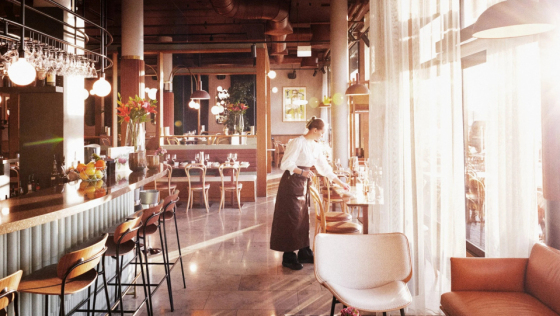 Waiting staff arranging glasses in Brasserie Rivoli, wine bar in Oslo, Norway.