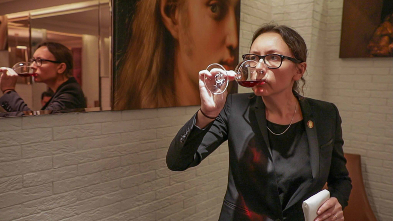 Pascaline Lepeltier tasting wine.