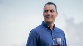French sommelier Fabien Etienne holding a glass of wine.
