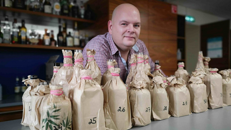 Star Wine List's Estonia Ambassador Kristjan Markii with wrapped wine bottles for a blind tasting.