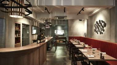 The bar and dining tables at Ma Cuisine wine bar in Singapore.