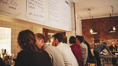 Guests at kitchen counter at Lilla Ego, Stockholm, Sweden.