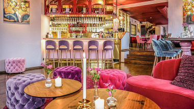 The bright pink dining room and bar of Tegelbacken restaurant in Stockholm, Sweden.