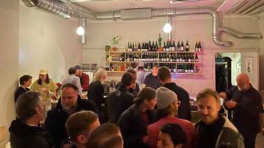 Guests and wine bottles at Bar Ninja wine bar in Stockholm, Sweden.