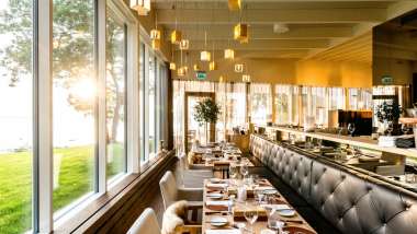 Seating and garden views at Noa Chef's Hall, a Michelin-starred restaurant in Tallinn, Estonia.