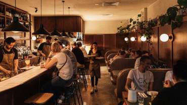 Guests at the bar and dining at Anchovy Bandit wine bar in Adelaide, South Australia.