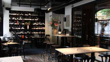Tables and wine bottles inside E & G restaurant and wine bar, Stockholm, Sweden.