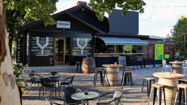 Wine barrels and tables on the outside terrace of Konvin wine bar and shop in Kojsko, Slovenia.