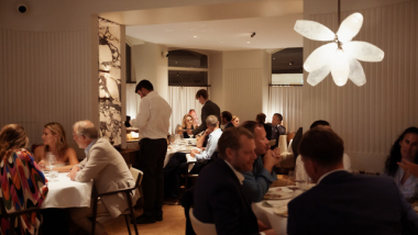 Guests eating and drinking at Michelin star Ergo restaurant in Stockholm, Sweden.
