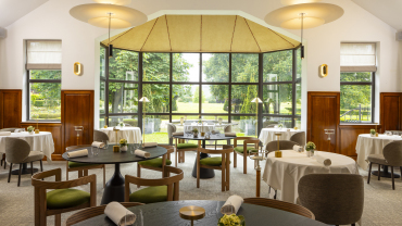 Dining room and garden view from Hostellerie La Briqueterie restaurant in Vinay, Champagne region, France.