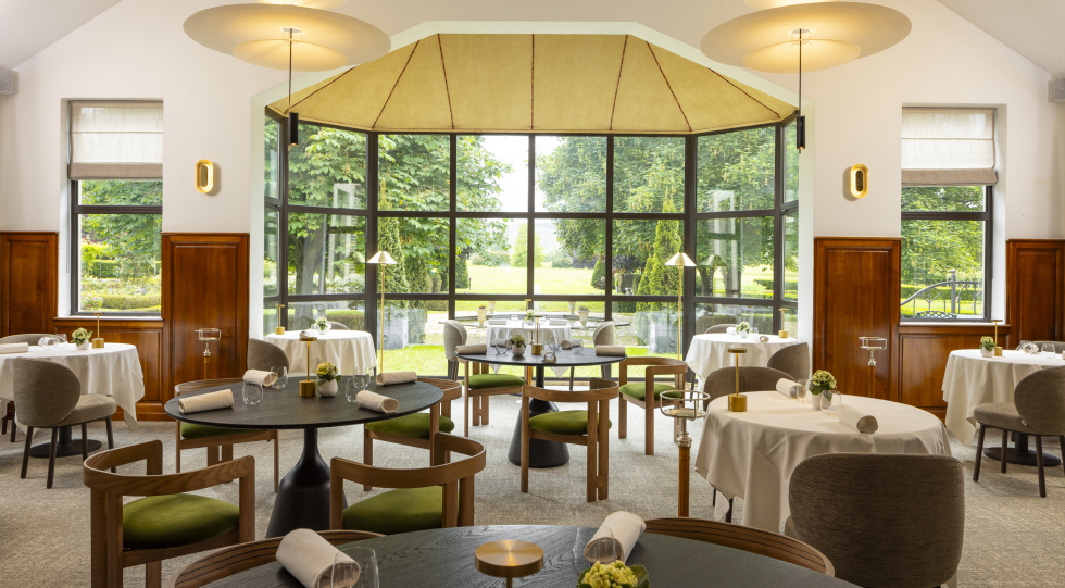 Dining room and garden view from Hostellerie La Briqueterie restaurant in Vinay, Champagne region, France.