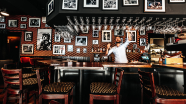 The bar and barman at Le Coq Bar wine cafe in Reims, Champagne region, France.