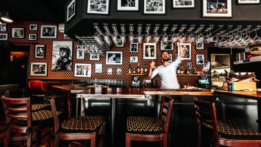 The bar and barman at Le Coq Bar wine cafe in Reims, Champagne region, France.