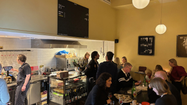 Guests drinking wine at Muscadet wine bar in Stockholm, Sweden.