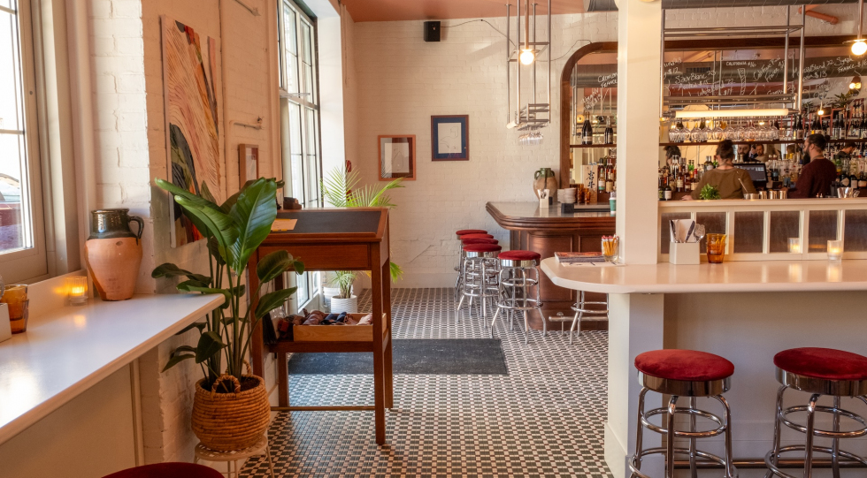 Dining room, banquette, accordian window at Familiar Creature, Saratoga Springs, USA.