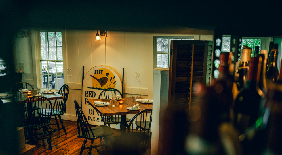 Dining room and wine bottles at the Pheasant, Dennis, USA.