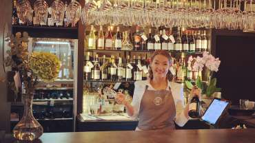 Staff behind the bar at Kungsholmens vinbar in Stockholm, Sweden.