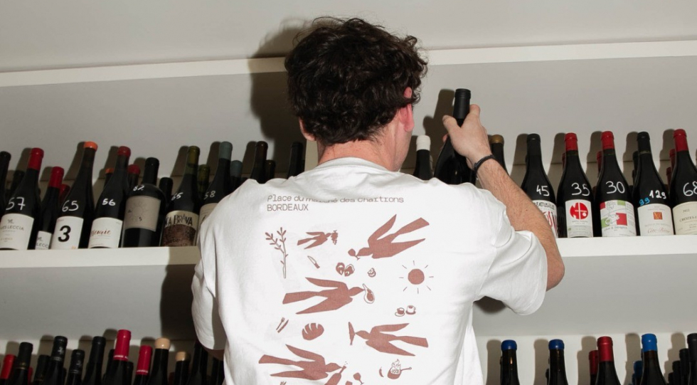 Selecting bottles at bistro Ganbarre, Bordeaux, France.